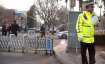 Chinese policemen stand guard at a road barricade in