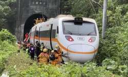 Rescue workers gather near one end of the train involved in