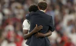 England's manager Gareth Southgate embraces Bukayo Saka
