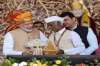 Prime Minister Narendra Modi hands over key of a house to a