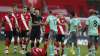 Everton's Lucas Digne, centre, is shown a red card by the