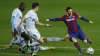 Barcelona's Lionel Messi, right, takes a shot at goal