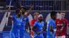 India's Gurjant Singh, left, celebrates after scoring during a men's field hockey match against Brit