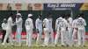 India's players watch the replay on a giant screen as they await the third umpire decision after an 