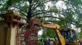 A bulldozer demolishing the fencing 